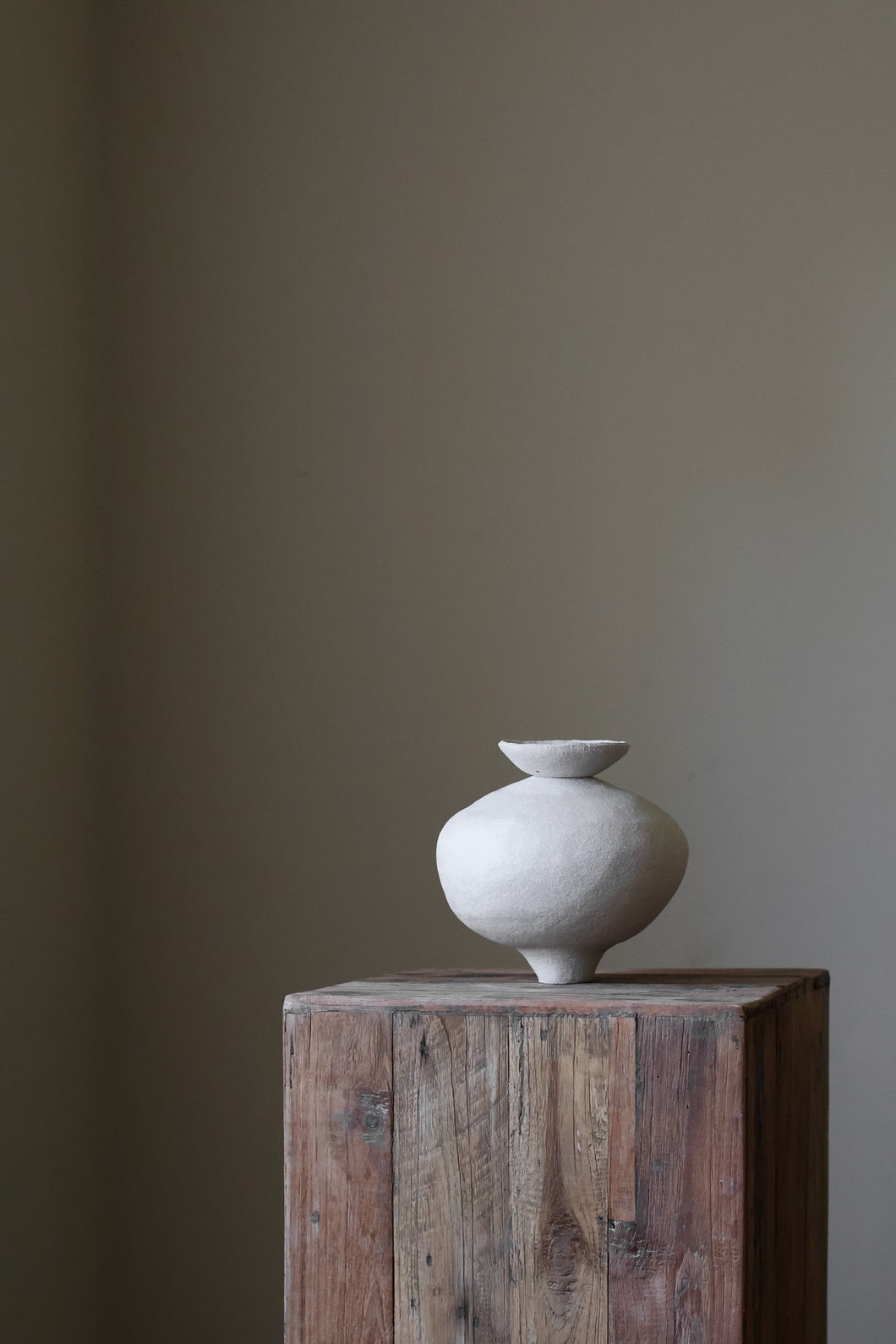 Unique sculptural vase with dish element by artist Hana, showcasing organic form and hand-built texture.